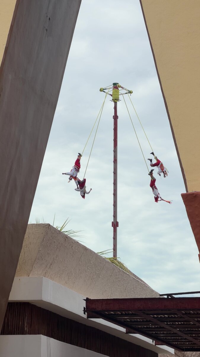 Papantla flyers performing on a tall pole at the Costa Maya cruise port in Mexico
