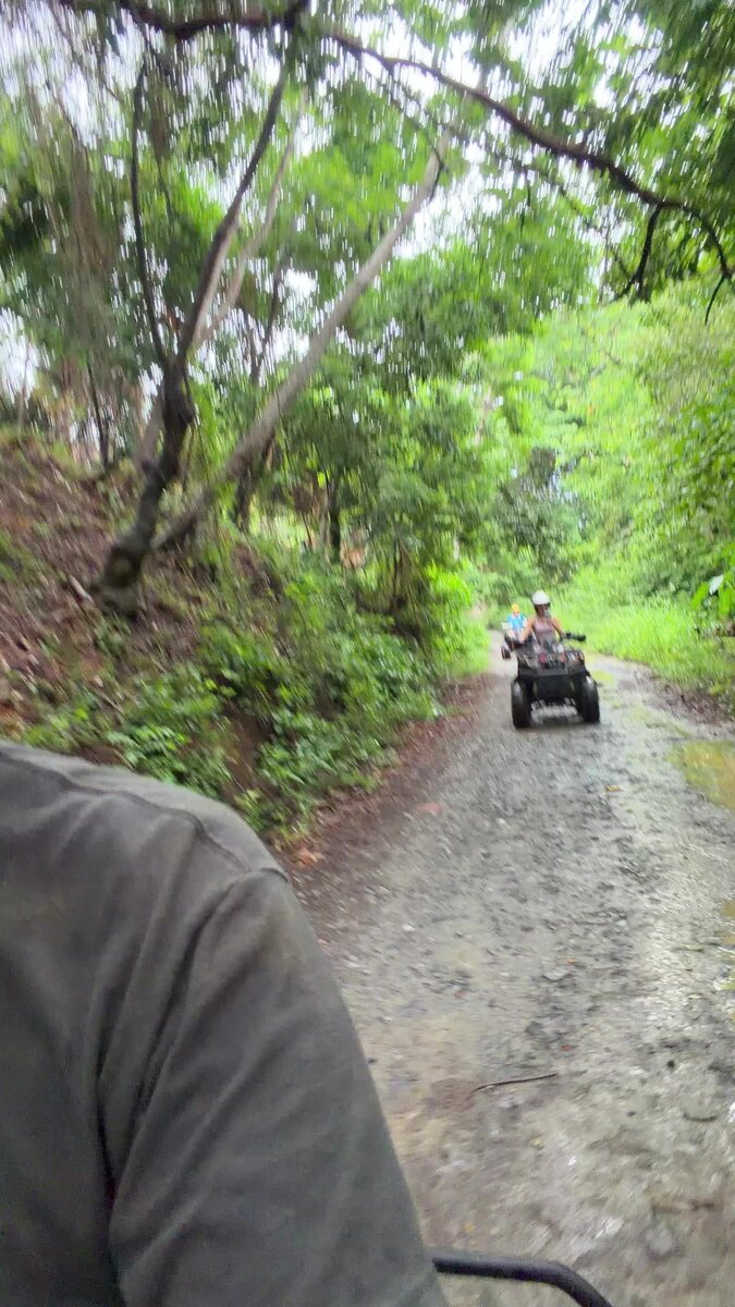 ATV shore excursion on a muddy jungle trail in Roatan, Honduras